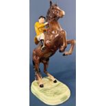 A Beswick figure of a rearing horse and huntsman in a Berkeley Hunt colourway jacket