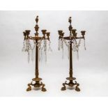 A pair of Neo-Classical gold finished column, five branch candlesticks with a central sconce with