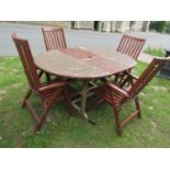 A stained and weathered teak D end extending garden table with bi-folding leaf, 170cm long x 121cm