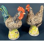 A pair of good quality Studio ware pottery figures of a cockerel and hen, indistinctly signed to the