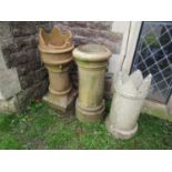 A weathered buff coloured cannon barrel chimney pot, 78cm high, together with two further crown