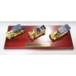 A Limited Edition 24 carat gold plated Collection of three Rolls Royce on a wooden plinth,
