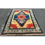 A thick pile modern Kazak carpet brightly coloured in orange and blue with a floral border, 272 cm x