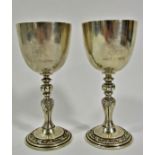 A pair of silver commemorative wine goblets and silver plated Christening set