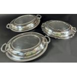 A pair of beaded Georgian style oval silver plated tureens, both with covers and two single silver
