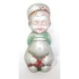 A metal figure of a naughty little Dutch boy, arms behind his back, with traces of original paint