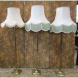 A set of three brass column lamp standards on square cut bases, together with three industrial green