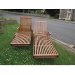 A pair of Canterbury Collection two wheeled portable garden stained teakwood sun loungers, with