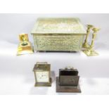 A heavily embossed brass slipper box with a pair of brass candlesticks a modern brass carriage