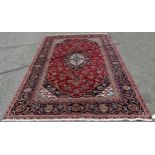 A good quality Central Persian Kashan carpet, with a central blue floral medallion and stylised