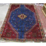 A Kazak Rug hand-knotted in pure wool with pale blue and burgundy tones and a repeated diamond