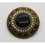 Victorian yellow metal mourning brooch with black enamel border and central agate within seed