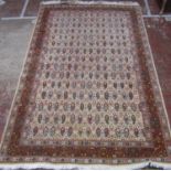 Persian rug with an all over field of paisley boteh in tones of natural wool and ochre, 257 x 166 cm