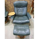 An Ekorness Stressless swivel and adjustable lounge chair and matching stool with dark stitched soft