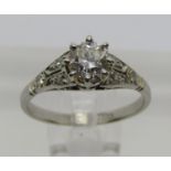 Platinum claw set diamond solitaire ring, 0.50ct approx, with further diamonds to shoulders, size G,
