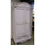 A painted armoire with arched pediment over a pair of three quarter length geometric moulded