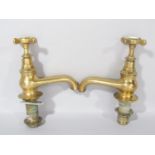 A pair of large brass bath taps, hot and cold, made by C. Winn & Co, Birmingham, with original screw