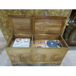 A fine quality arts and crafts style music cabinet in pale english walnut, commissioned in the early