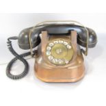 A vintage copper and Bakelite continental rotary telephone converted with later BT compliant cable.