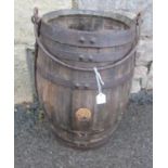 A vintage coopered oak and steel banded barrel shaped pail, with loop handle, the main receptacle
