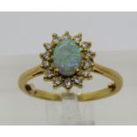 18ct opal and diamond cluster ring, London 1983, size J/K, 3.8g (sizing beads)