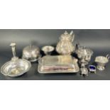 A mixed selection of silver plated items including an ornate and richly engraved teapot, muffin dish