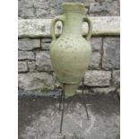 A small Mediterranean weathered buff coloured terracotta amphora, with moulded loop handles,