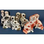 A pair of 19th century Staffordshire spaniels with abstract rust coloured patches, together with a
