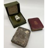 A small collection of musket balls and other small metallic finds, two small prayer books