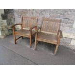 A pair of Canterbury Collection stained and weathered teak garden open armchairs with slatted