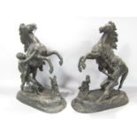 A pair of spelter Marley horse sculptured group of a rearing horse with groom, faintly signed