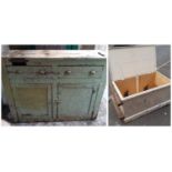 An antique rustic painted pine kitchen dresser enclosed by a pair of panelled doors beneath two