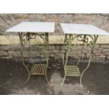 A pair of light green painted iron work conservatory or garden table with simple scrollwork detail