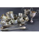Ten assorted silver napkin rings, two smaller silver trophies and a plated sugar tong, 10oz approx