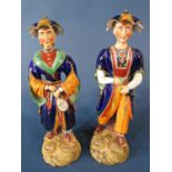 Mid 19th century pair of Dudson Staffordshire figures richly painted and raised on circular bases,