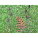 A pair of decorative ornamental heavy gauge steel garden teasel border stakes, together with a