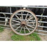 An antique cart wheel with chamfered spokes and iron rim 103cm in diameter