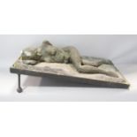 A fibre glass and resin study of a reclining female nude set in a tilted metal frame, 56.5cm x