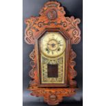 An Ansonia gingerbread wall clock with shaped and fretted outline with eight day striking movement