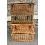Four contemporary wicker hampers with leather straps, 52c long and smaller