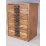 A printers letterpress cabinet by Caslon comprising bank of 12 drawers, all with inner partition and