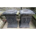 A pair of painted and weathered cast composition stone pedestals of square cut and stepped form