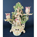 A 19th century continental porcelain candelabrum with bocage back to the centre a female playing a