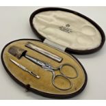 A four piece travelling sewing set by Asprey 166 Bond Street comprising a needle case, thimble,