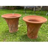 A pair of weathered terracotta flower pots in the form of lattice baskets 34 cm diameter x 32 cm