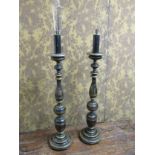 A pair of ebonised wooden standard lamps, with chinoiserie gilded decoration