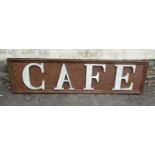 A vintage style café sign with raised composite letters, mounted on a rectangular painted wooden