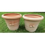 A pair of terracotta planters of circular tapered form with moulded rims and relief detail, 46 cm