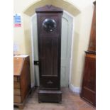 An oak longcase clock c.1930, the glazed case enclosing a circular anodised dial and three train