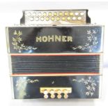 A Hohner accordion with steel reeds, Made in Germany, in working order but with some wear and tear.